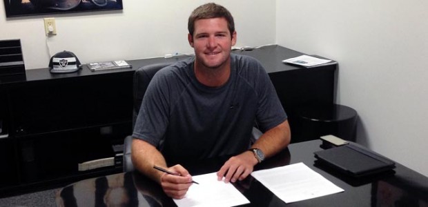 Tyler Wilson signs his pro football contract with the Oakland Raiders